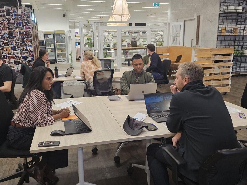 Innovators talking through ideas at a shared table