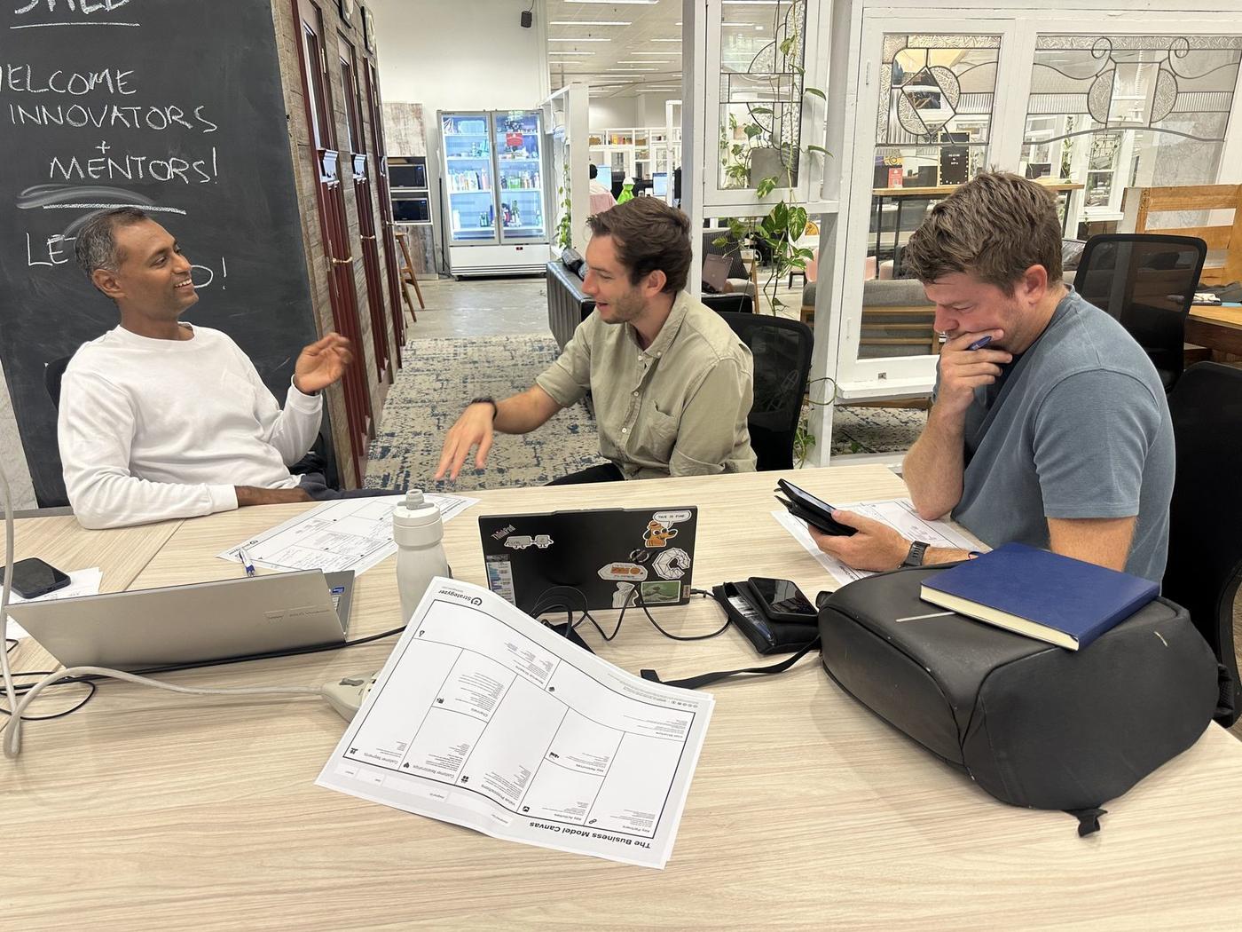 Innovators and a mentor working together at an Innovation Shed session