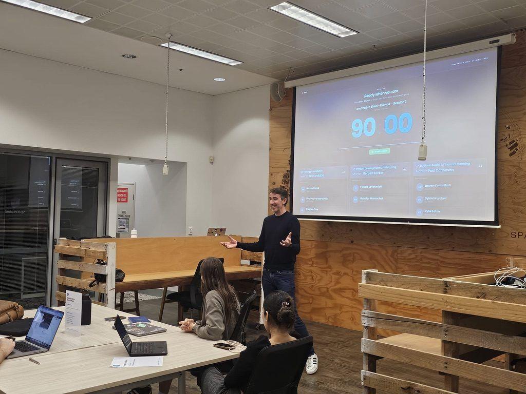 A session being introduced in front of the schedule screen