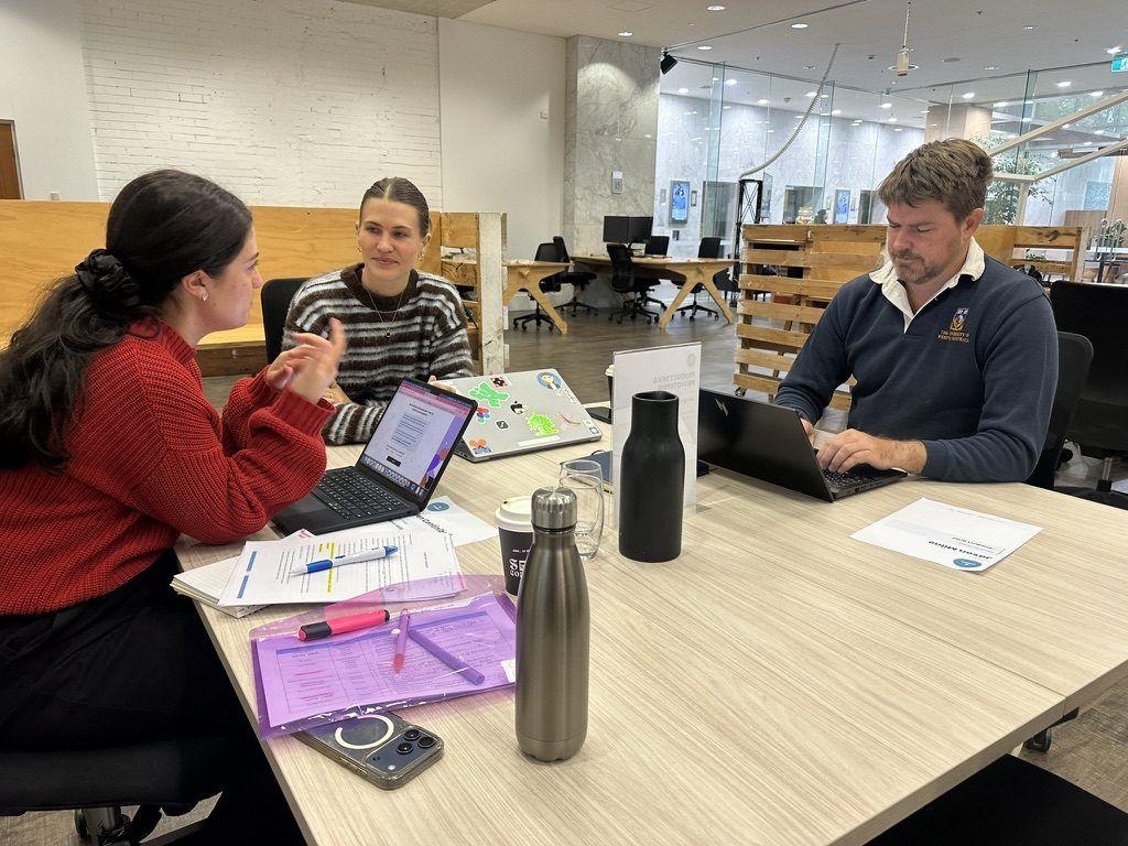 A small group working together at a table