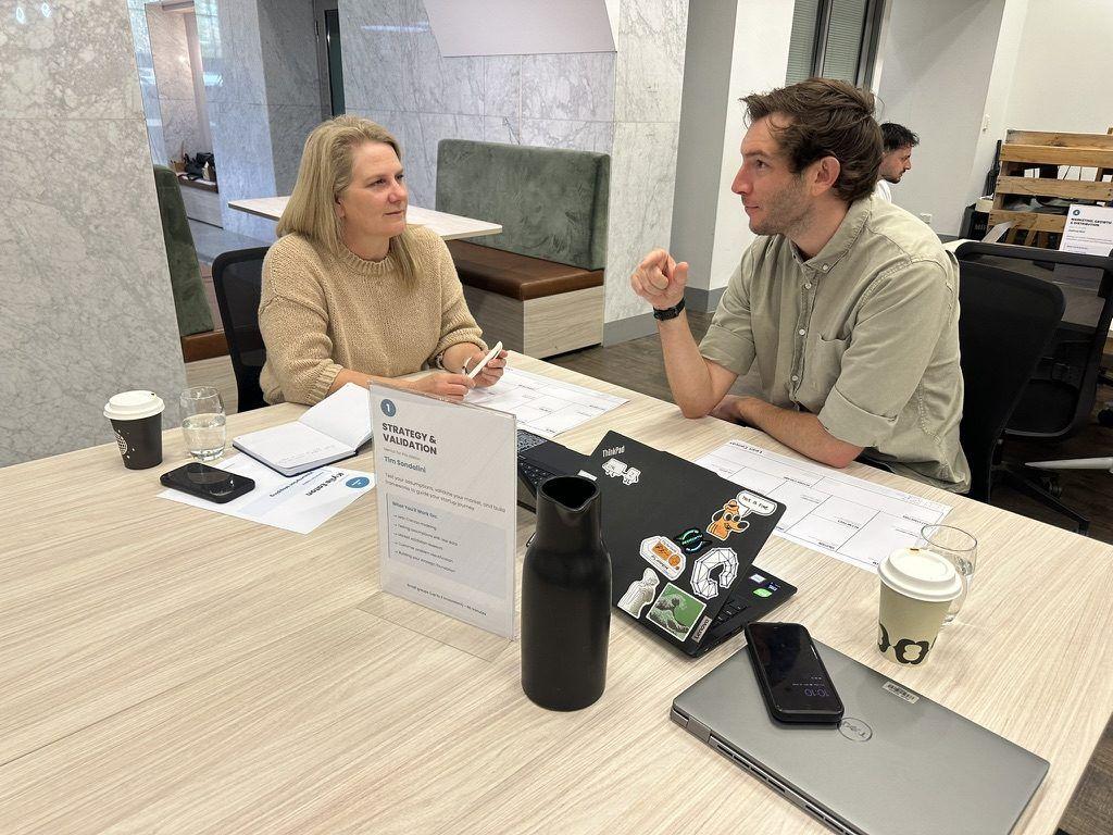 Two people working at the Strategy and Validation station