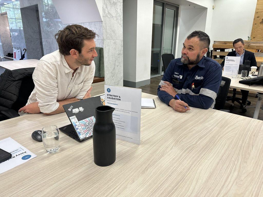 A mentor and founder in conversation at the Strategy and Validation station